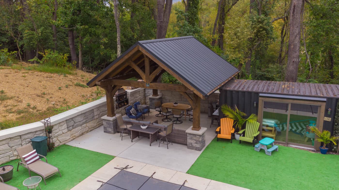 The Vista A-Frame Pavilion covering an outdoor seating and dining area in a backyard