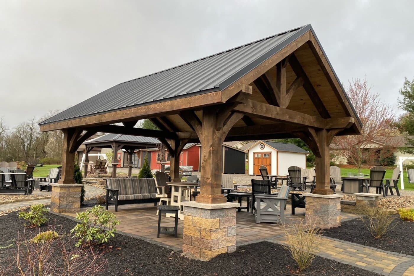 Custom timber frame pavilion in Elyria Ohio with concrete post stands and seating underneath