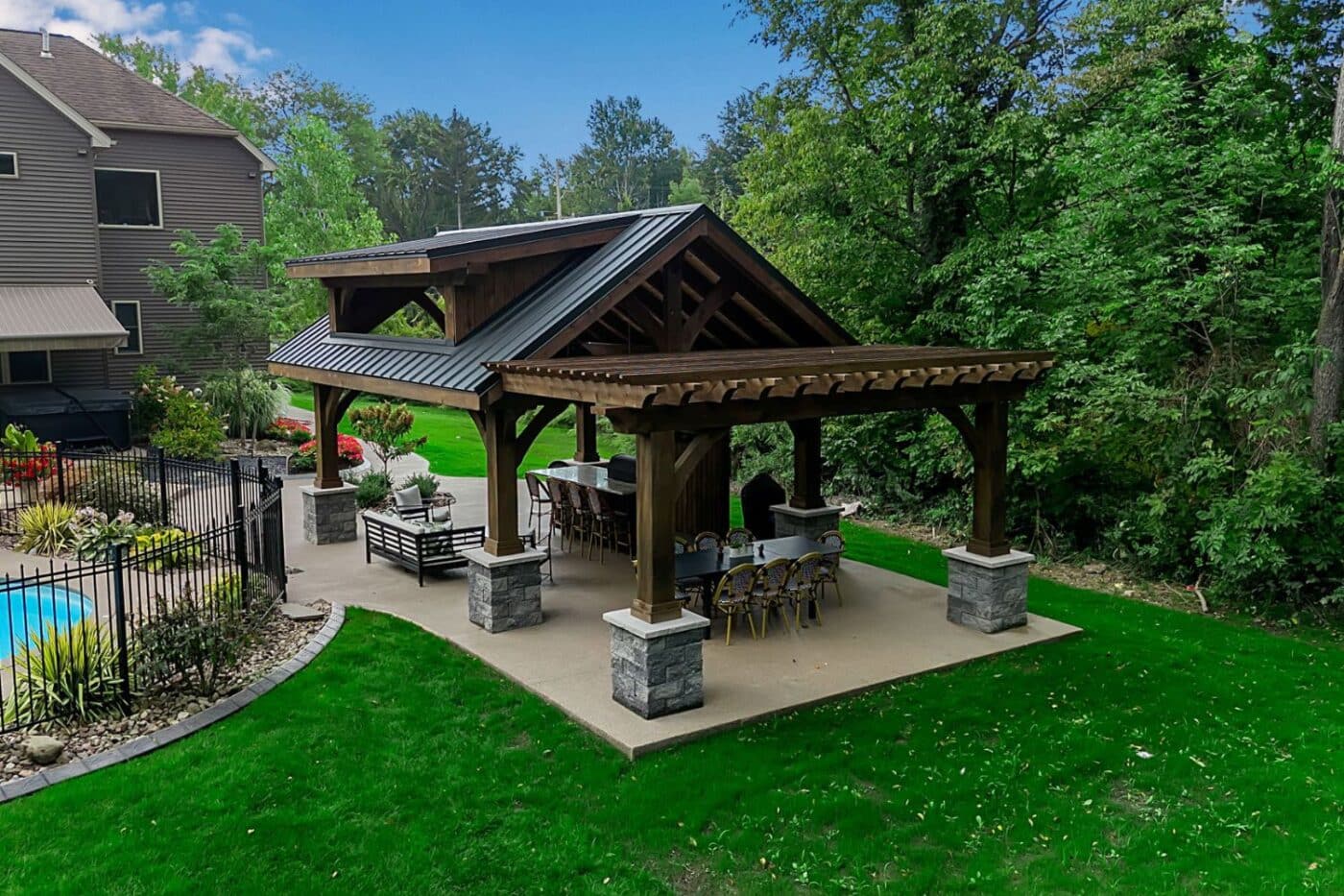 Custom structures in painesville featuring pavilion and pergola over patio, besides pool