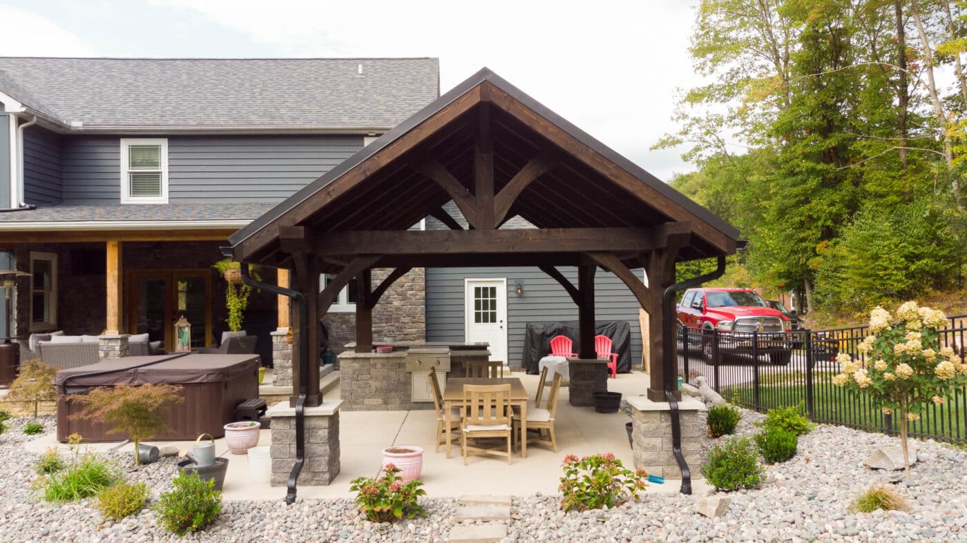 The Vista A-Frame Pavilion over a table in a backyard