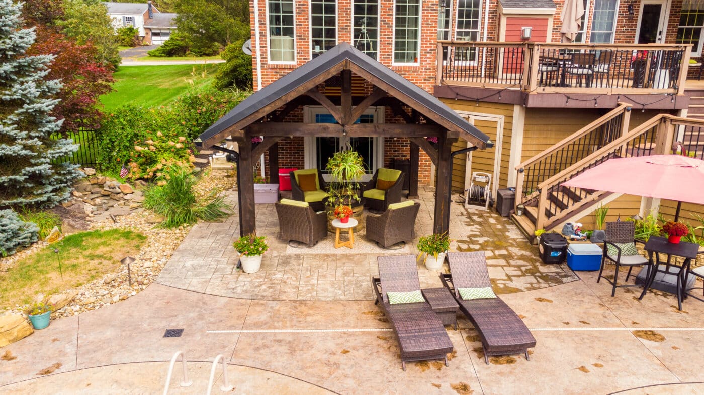 front of a timber frame pavilion by the pool with seats in Wexford PA