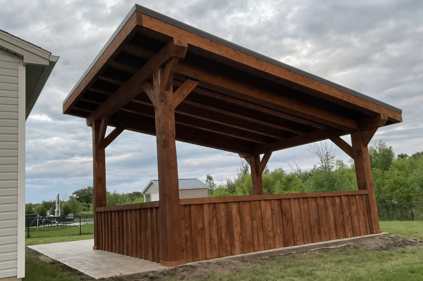 The Evergreen lean to pavilion with wood siding and metal roof