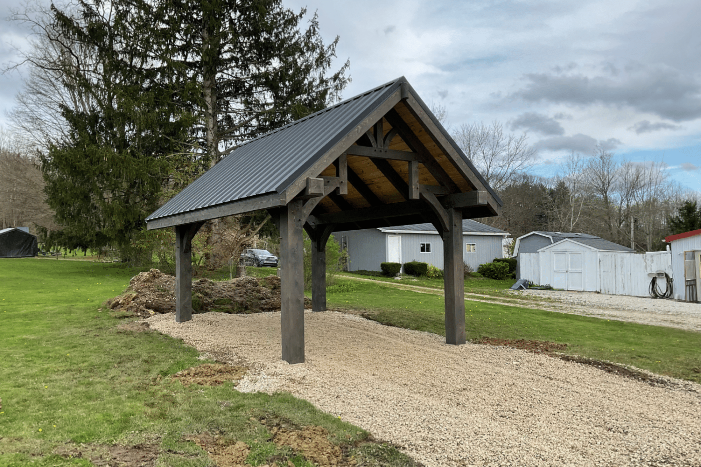 wooden backyard pavilion with black metal roofing