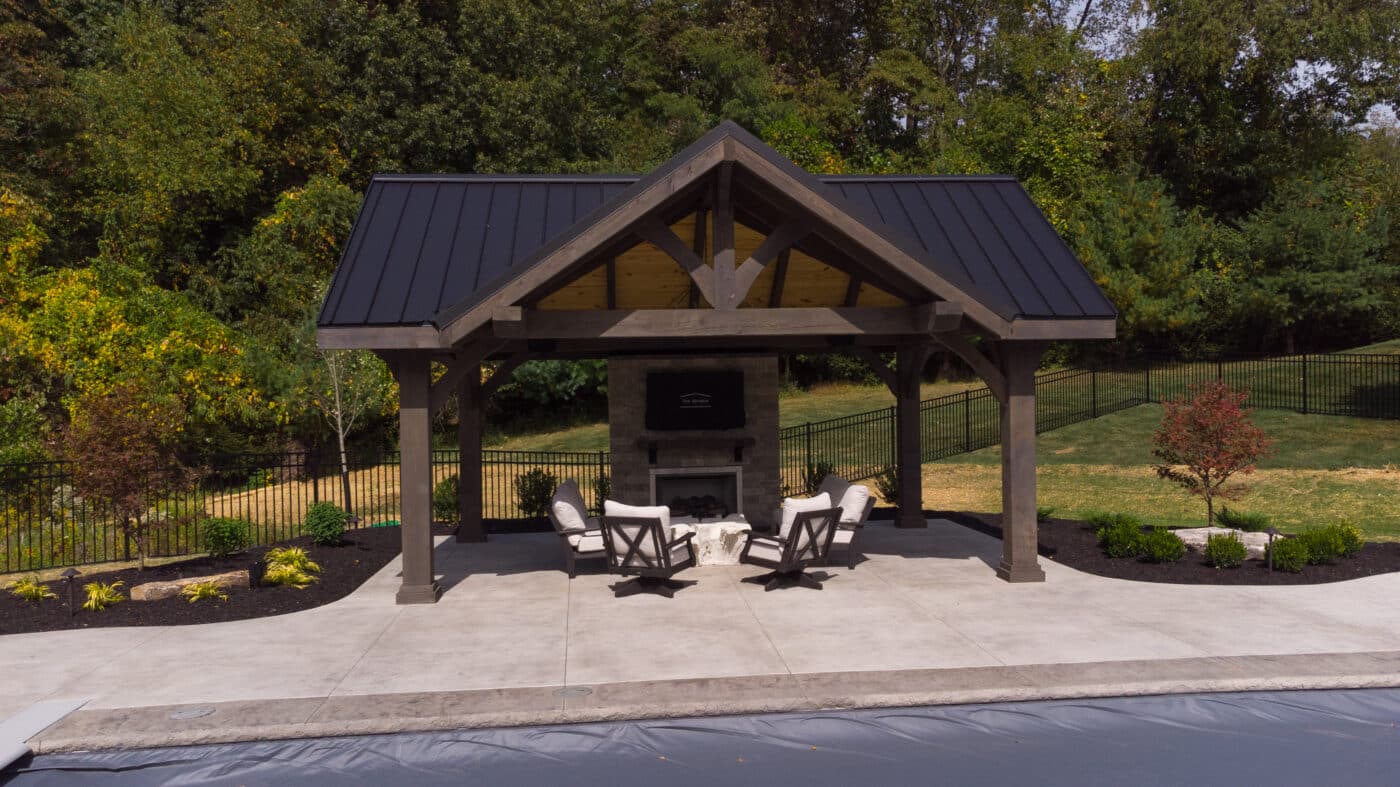 Timber frame deluxe pavilion with black metal roof near pool in Ohio