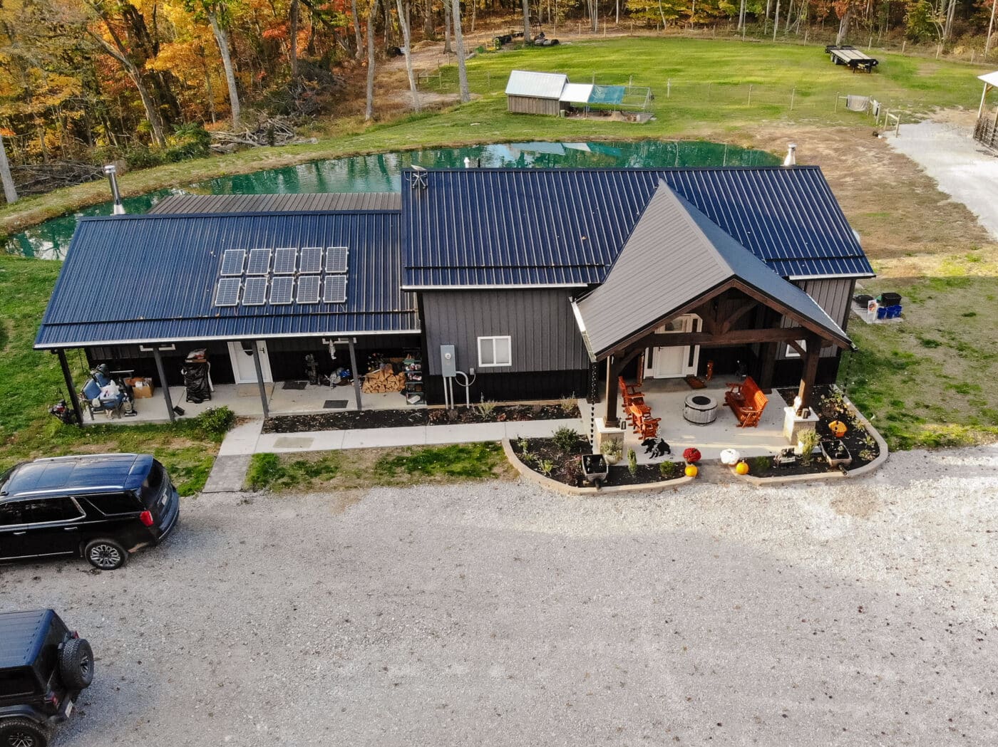 aerial shot of timber frame porch connected to house near pond in reedsville ohio