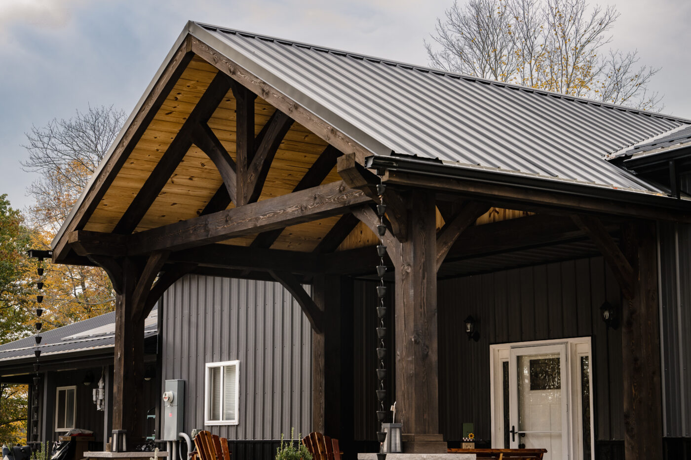 timber frame wood used for porch with black metal roof in ohio